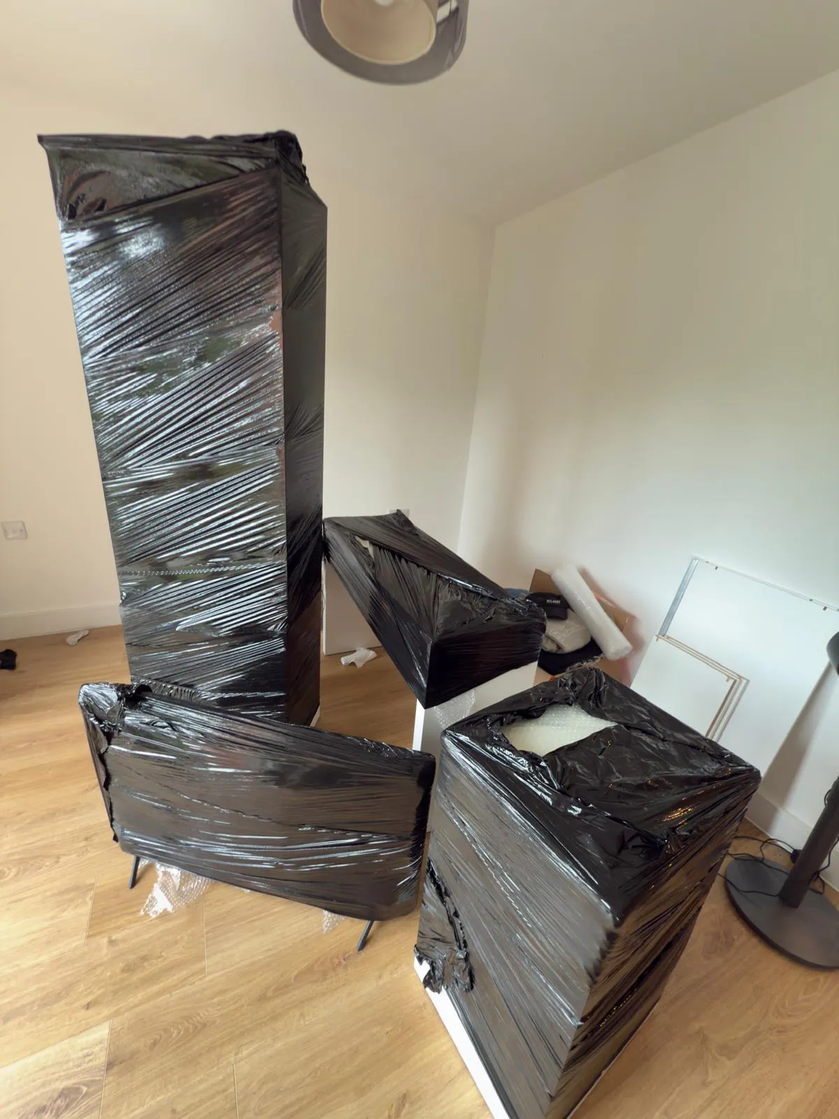 Upright piano padded with blankets ready for a move